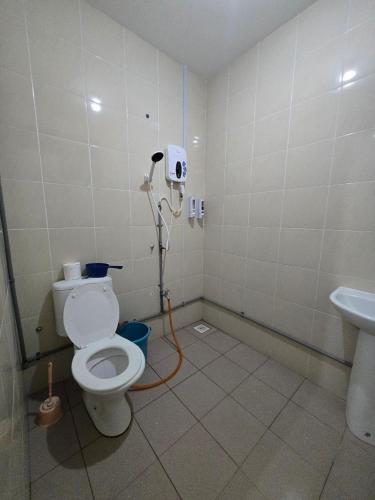 a bathroom with a toilet and a sink at AymanSyahir in Mukah