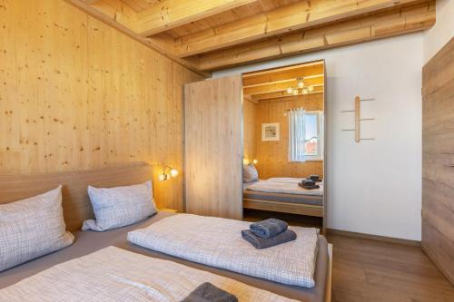a bedroom with two beds and a cross on the wall at Hubertus in Dietingen