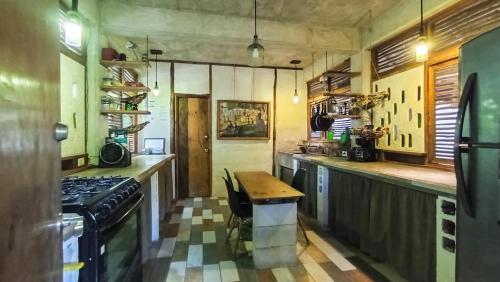 a kitchen with a table and a stove top oven at Guarumbo in Bacalar