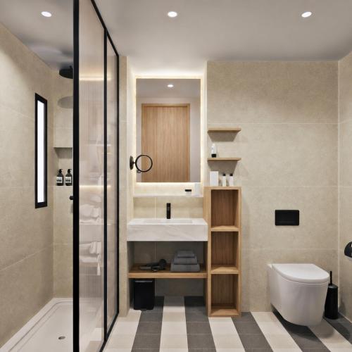 a bathroom with a toilet and a sink and a shower at Hotel Le Morgane in Chamonix