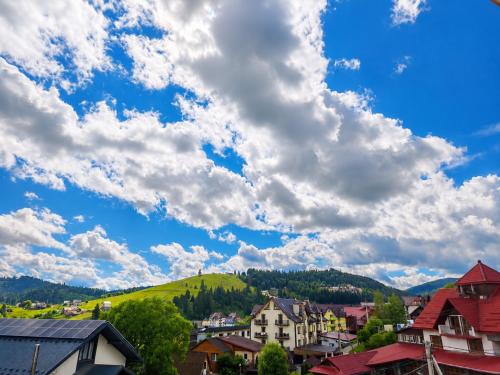 a town in the mountains under a cloudy sky at SPA Resort HeRICH in Bukovel