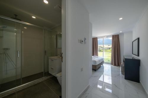 a bathroom with a toilet and a shower and a bed at Atlantis Malibu by Carrington in Kyrenia