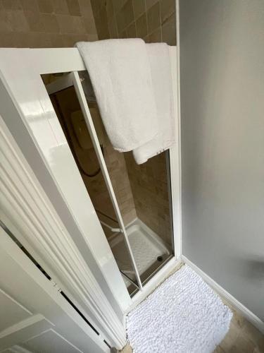 a bathroom with a mirror and a towel at Magic of Mullingar in Mullingar