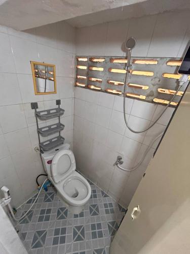 a bathroom with a toilet and a shower at Home Frog Guesthouse in Phnom Penh