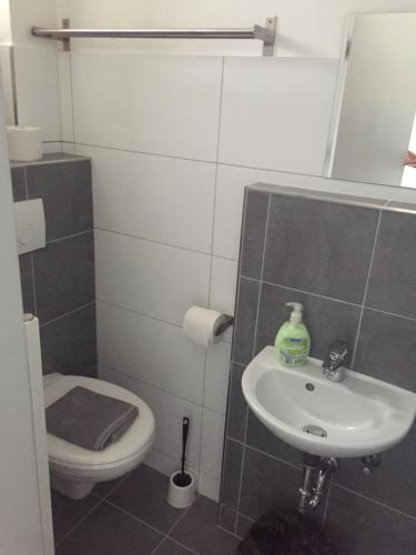 a bathroom with a sink and a toilet at P63 City Rooms Nürnberg Center in Nürnberg
