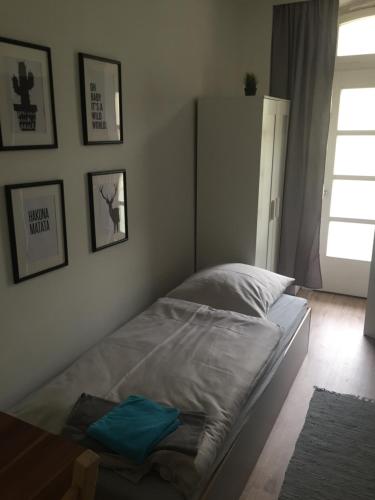 a bedroom with a bed with a blue object on it at P63 City Rooms Nürnberg Center in Nürnberg