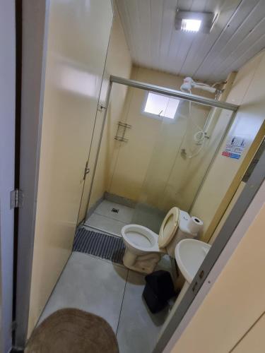 a small bathroom with a toilet and a sink at Condomínio Gold in Três Lagoas