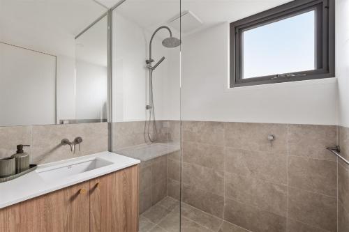 a bathroom with a sink and a glass shower at The Cape Collective 5 in Margaret River Town