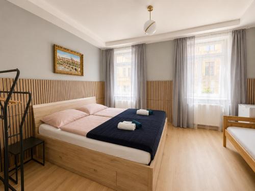 a bedroom with a bed with two towels on it at Kael Apartment 2 in Teplice
