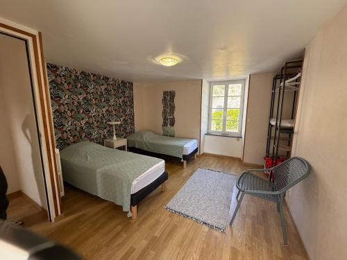 a bedroom with two beds and a window at Le Cosy in Coutances