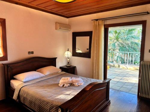 a bedroom with a bed with two stuffed animals on it at Gate to the blue in Áyioi Apóstoloi