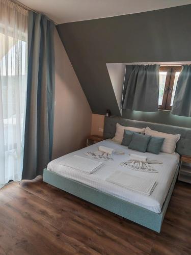 a bedroom with a large bed in a room at Coral Guest House in Obzor