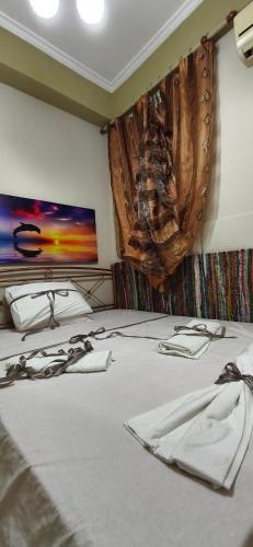 a bed in a room with a painting on the wall at Mama's Home in Chios