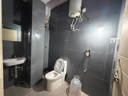 a small bathroom with a toilet and a sink at S L N paradise in Chik Bānavar