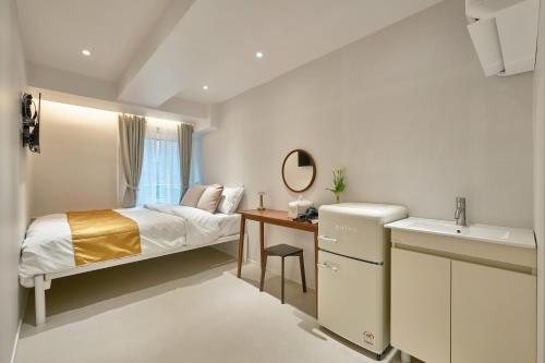 a small bedroom with a bed and a sink at Seoul Jongno Hostel in Seoul
