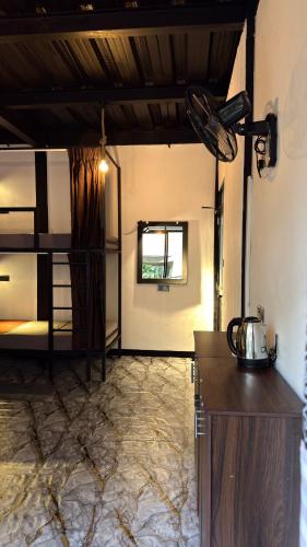 a room with a kitchen and a bunk bed at A Lounge Hostel in Ella