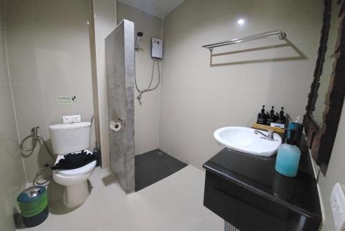 a bathroom with a sink and a toilet and a shower at DB Studios Samui - Adults Only in Lamai