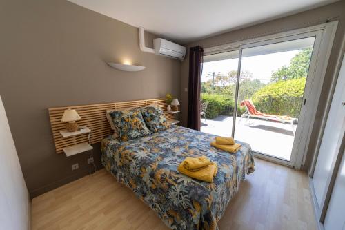 a bedroom with a bed and a large window at Soleil de Provence in Nyons