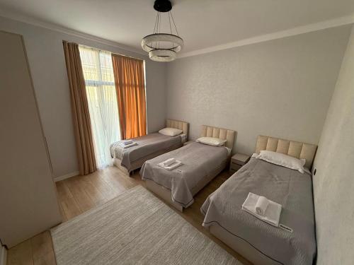 a room with two beds and a window at Вип Вилла у берега in Chon-Sary-Oy