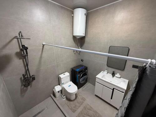 a small bathroom with a toilet and a sink at Вип Вилла у берега in Chon-Sary-Oy