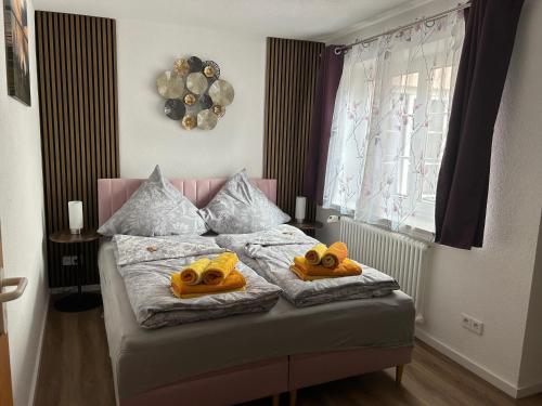a bedroom with a bed with two stuffed animals on it at Loggia in Stockach