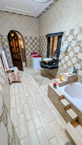 a bathroom with a tub and a sink at Nagar Villa Apartments in Luxor