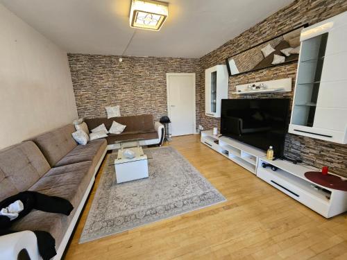 a living room with a couch and a flat screen tv at Nice 3 Rooms apartment in Copenhagen