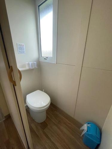 a small bathroom with a toilet and a window at Camping 3 étoiles - Piscine - ccbgaia in Châtel-Chéhéry