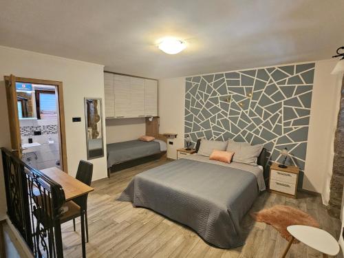 a bedroom with a bed and a wall at Villa Kos1 in Erkovčići