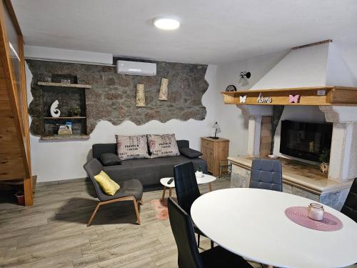 a living room with a couch and a table at Villa Kos1 in Erkovčići