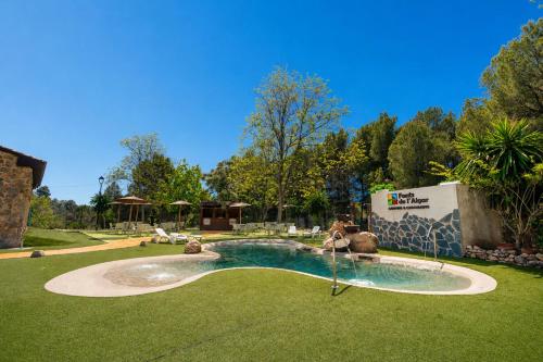 a swimming pool in a yard with a slide at Kampaoh Fonts d' Algar in Callosa d'en Sarrià