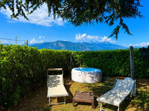 two chairs and a tub with mountains in the background at FUGA ROMANTICA - Panoramica in Almese