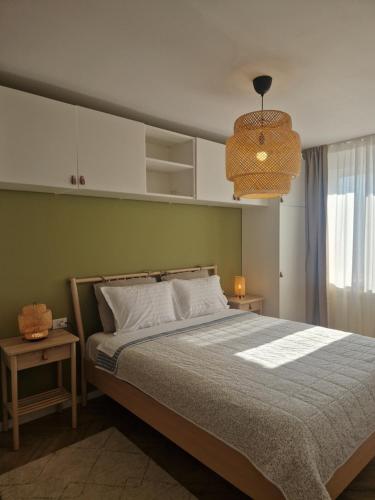 a bedroom with a bed and a pendant light at Ultracentral Mangalia seaside exclusive in Mangalia