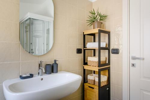 a bathroom with a white sink and a mirror at Dimore Abruzzo - Borgo 27 in Celano
