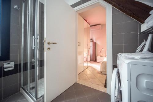 a bathroom with a walk in shower next to a toilet at Venier Apartment in Venice