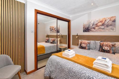 a hotel room with two beds and a mirror at 1 Bed in Dollar oc-95872 in Powmill