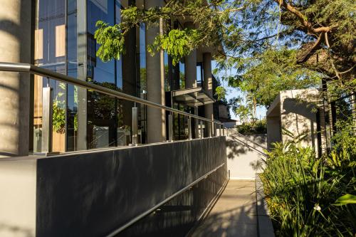 a building with a railing on a sidewalk at Stylish Luxury Apartment - Fully Equipped in Asunción