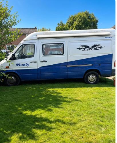a white and blue van parked in the grass at Bramcote House in Bramcote