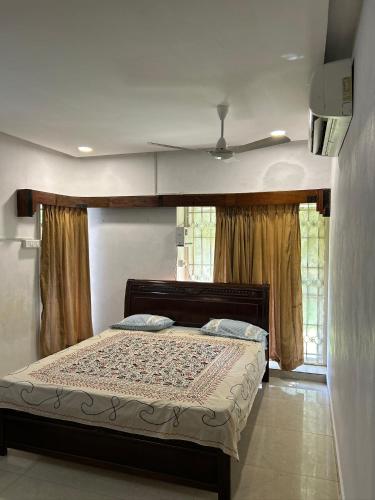 a bedroom with a bed with a ceiling at AAC in Chennai