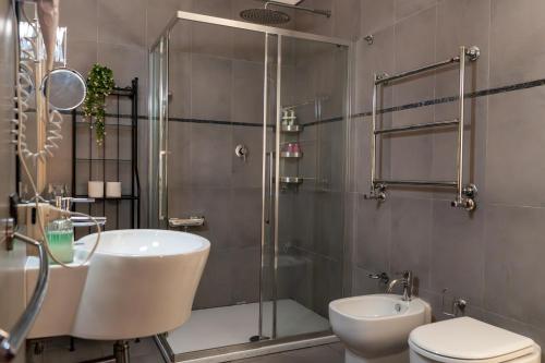 a bathroom with a shower and a sink and a toilet at Villa Aureliana with pool near San Peter in Rome