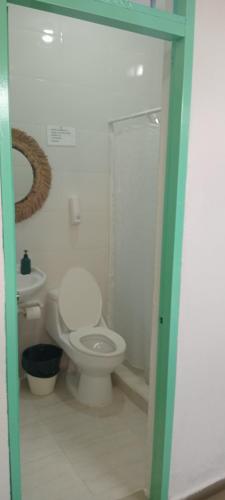 a bathroom with a toilet and a sink at Hostal Johnnier Macao Punta Cana in Punta Cana