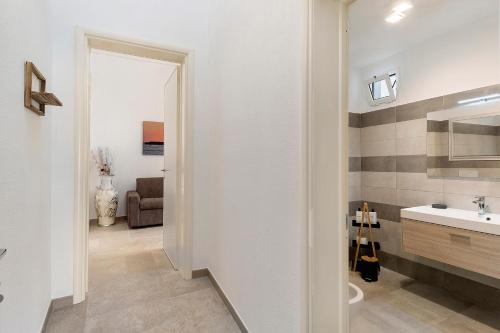a bathroom with a sink and a toilet in a room at L'Aurora Bed and Breakfast in Ugento