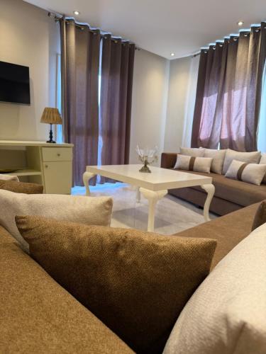 a living room with a couch and a table at Panoramic Sea View Apartment in Riffiene