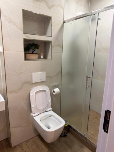 a bathroom with a toilet and a shower at Resident park apartment in Plovdiv