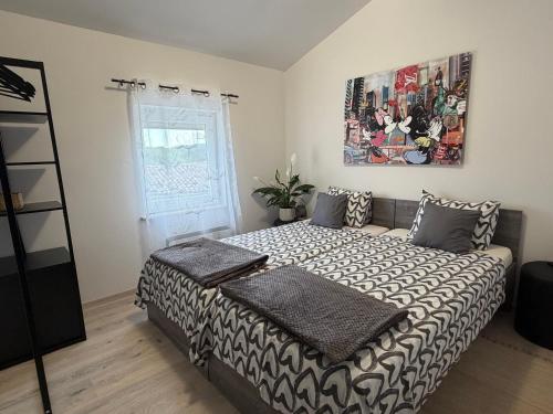 a bedroom with a bed and a painting on the wall at 7sopot in Buzet