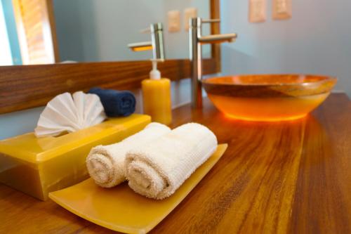 a bathroom counter with a sink and a towel at vivo resort in Chano