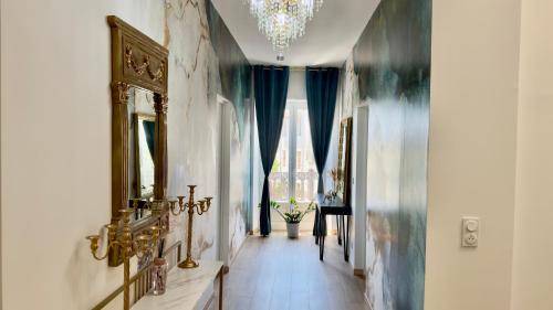a hallway with blue curtains and a chandelier at Les Anges de Sigean, Chambres d'hôtes de Luxe,Rooftop Panoramique avec Jacuzzi in Sigean