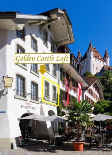 a white building with a sign for a golden castle lot at 120m2 l Golden Castle Loft l Old Town l Thun in Thun