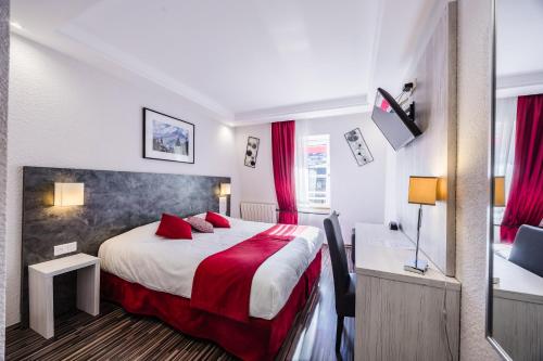 a hotel room with a large bed with red pillows at Hôtel de France Contact-Hôtel in Évian-les-Bains