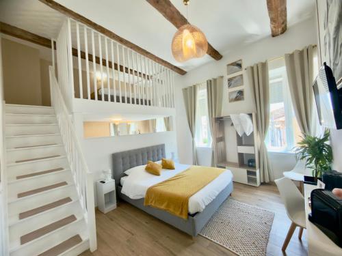 a white bedroom with a bed and a staircase at Les Anges de Sigean, Chambres d'hôtes de Luxe,Rooftop Panoramique avec Jacuzzi in Sigean